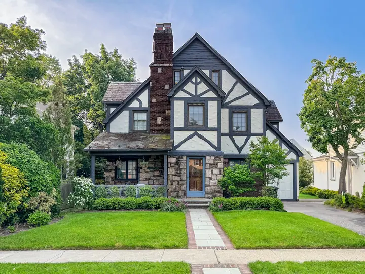 Tudor-style home with a stone chimney