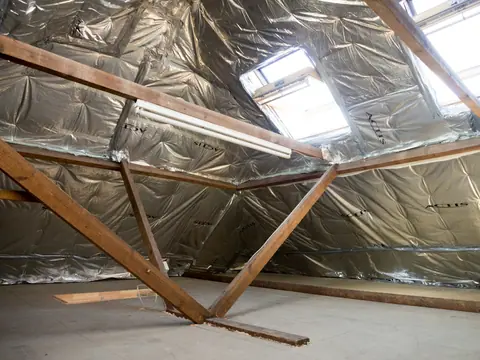 Reflective attic insulation under skylights